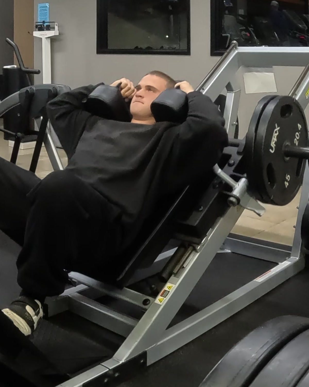 Markus training on a hack squat machine.