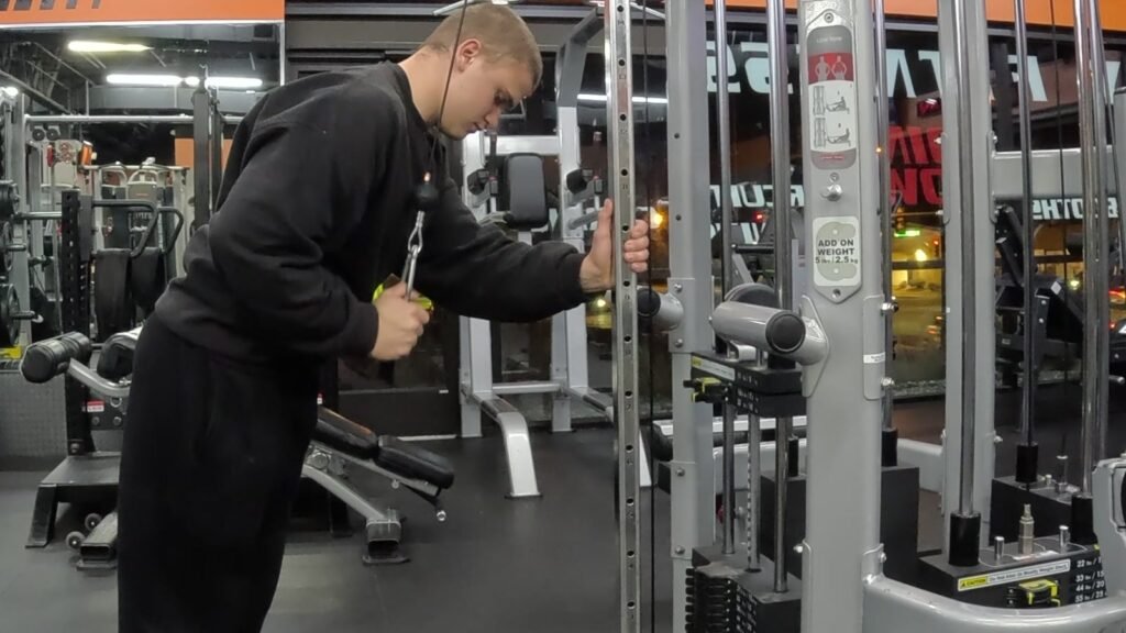 Markus performing a single-arm cable triceps exercise.