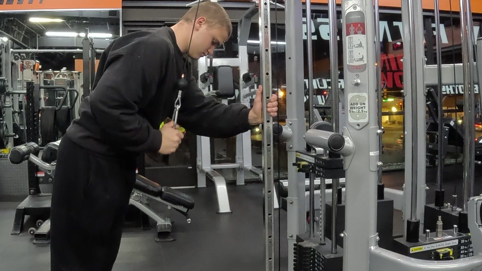 Markus performing a single-arm cable triceps exercise.