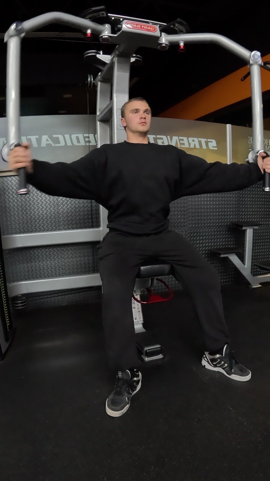 Markus performing a machine chest fly.